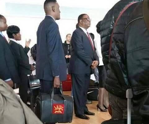 Peter Mutharika queues for plane
