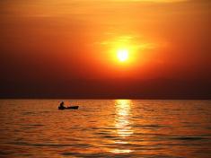 Malawi - Sunrise over the calm waters of Lake Malawi.