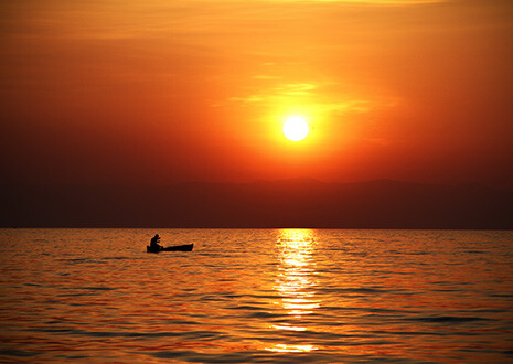 Malawi - Sunrise over the calm waters of Lake Malawi.