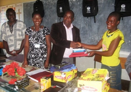 MJ DEM hands over the items to one teen mother in a symbolic ceremony