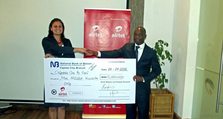 Village Reach Country Director Carla Blauvelt with Airtel MD Charles Kamoto