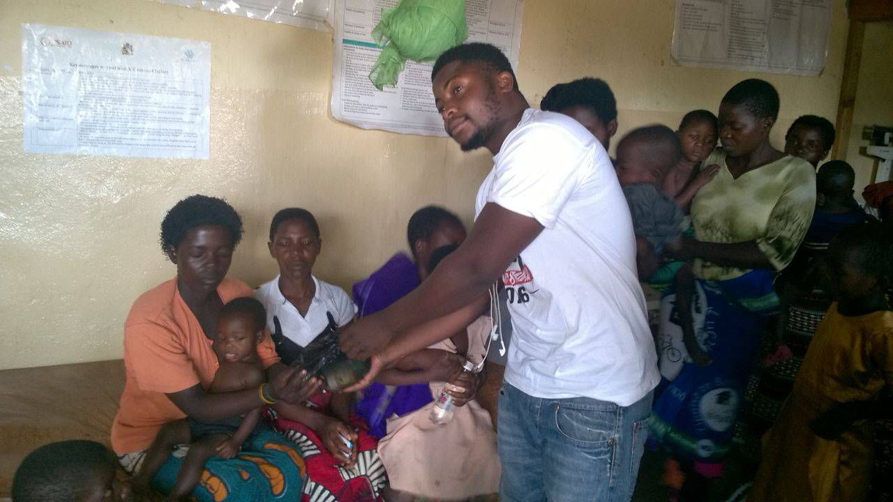 One of the students giving a patient the items.