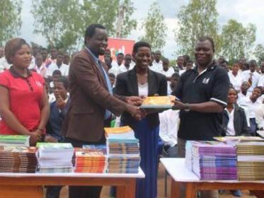 All smiles - Kadango (R) presenting books to Milazie (M) and Tembo( L)