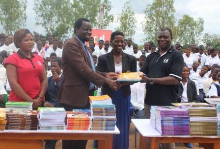 All smiles - Kadango (R) presenting books to Milazie (M) and Tembo( L)