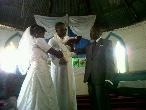 A Pastor blessing a new couple