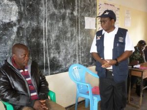 1. Mmadi (standing) addresses the concern raised during the meeting to STA Mulenga (seated)