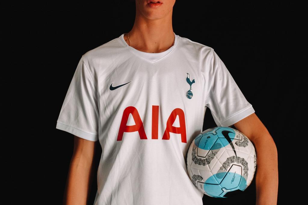 The image shows a person wearing a Tottenham Hotspurs jersey