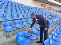 An official inspects damaged chairs at Bingu National Stadium