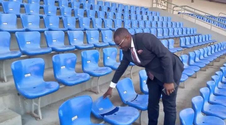 An official inspects damaged chairs at Bingu National Stadium