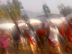 Malawi Congress Party supporters leave a rally carrying maize flour