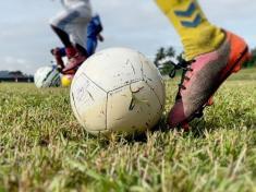 A footballer, football and football boots. Kids playing football were sexually abused in Gabon