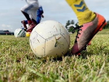 A footballer, football and football boots. Kids playing football were sexually abused in Gabon