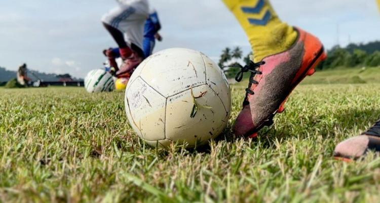 A footballer, football and football boots. Kids playing football were sexually abused in Gabon