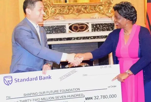 First Lady Monica Chakwera receiving donation from Wang Hao, Chinese Charge De Affair,