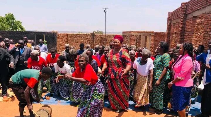 Minister of Gender, Community Development and Social Welfare Jean Sendeza in melon dress during a visit to Mai Mbambande elderly home