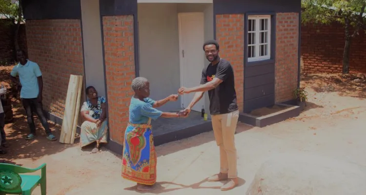 Fadeth Furnisher Managing Director Richard Chirwa handing over the house to the woman