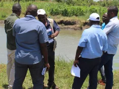 Napoleon Dzombe at the farm with Department of Fisheries officials