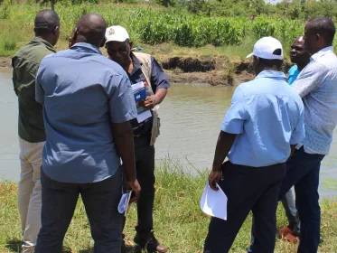 Napoleon Dzombe at the farm with Department of Fisheries officials