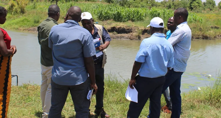 Napoleon Dzombe at the farm with Department of Fisheries officials