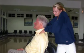 Bill Clinton lies back in a chair as he receives a neck massage from a former victim of Jeffrey Epstein. MEGA