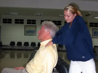 Bill Clinton lies back in a chair as he receives a neck massage from a former victim of Jeffrey Epstein. MEGA