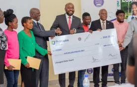 Chairperson of the Lilongwe Water Board, Inkosi Mbelwa IV presenting cheques to LUANAR's Chair of Council, Professor Zachary Kasomekera and students