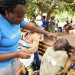 Child receiving oral polio vaccine in Malawi.
