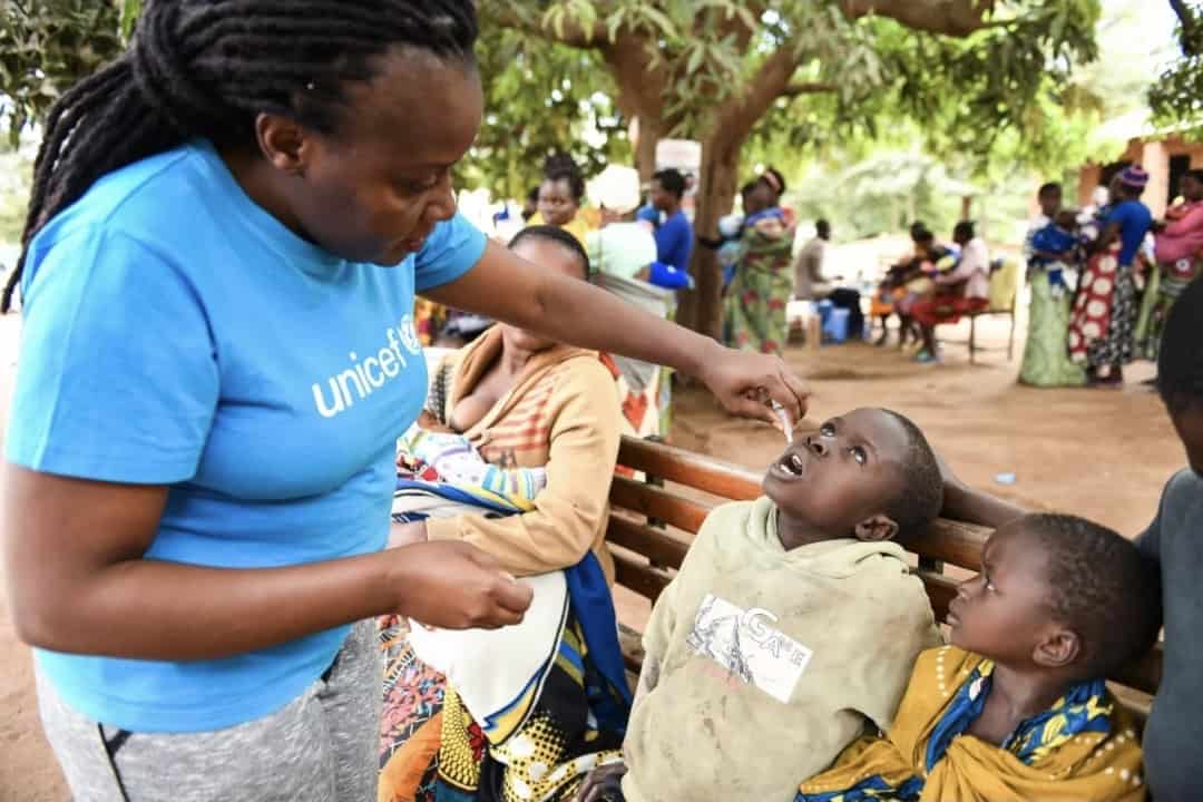 Child receiving oral polio vaccine in Malawi.
