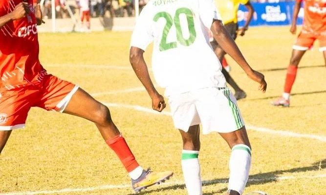 FCB Nyasa Big Bullets and Moyale Barracks players tussle for the ball during a TNM Super League match at Joyce Chitsulo Stadium in Mwanza