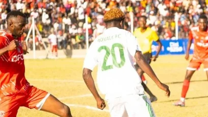 FCB Nyasa Big Bullets and Moyale Barracks players tussle for the ball during a TNM Super League match at Joyce Chitsulo Stadium in Mwanza