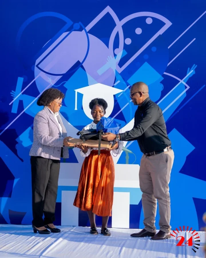 Nyirenda Left Handing Over Several Items To The Scholarship Beneficiary Alongside Samson Mzungu Right Nbm Mzuzu Service Centre Manager 002- Malawi24